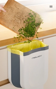 Hanging foldable kitchen waste bin mounted on cabinet door for effortless waste disposal