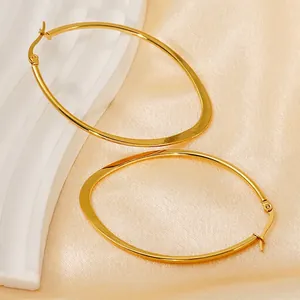 Minimalist 18K gold plated stainless steel irregular oval hoop earrings on silk background