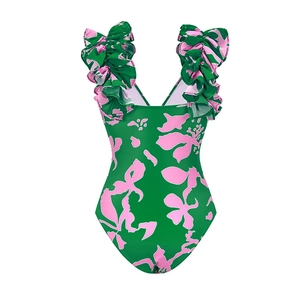 Detail of pink floral print and ruffle shoulder strap on dark green one-piece swimsuit