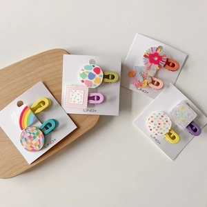 Vibrant geometric acrylic hair clips set for girls featuring colorful rainbow and star patterns