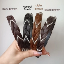 Detailed close-up of four braided headbands with sparkling rhinestones in assorted hair colors
