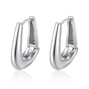 Macro shot of polished silver U-shaped earrings with reflective smooth metallic finish