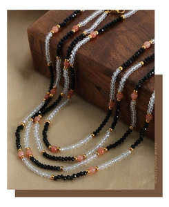 Detailed macro view of retro faceted black and pink beads on a vintage multi-layer necklace