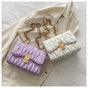 Close-up of quilted PU leather texture and gold chain strap on stylish shoulder bags