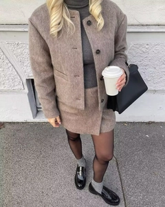 Chic taupe wool blend jacket and skirt set worn by a model in a city street setting