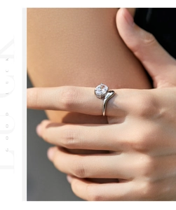 Detail of s925 silver ring featuring a round diamond and irregular geometric twisted band