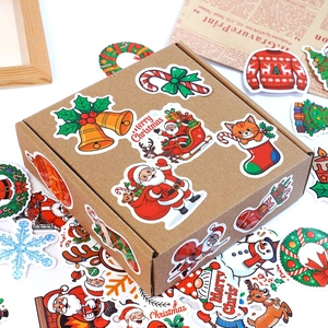 Christmas vinyl stickers with Santa and reindeer on a kraft gift box, festive decoration
