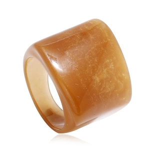 Macro shot of amber resin ring with fine gold glitter on a clean white background