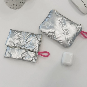 Detail of silver quilted pouches with bow embossing and pink drawstring closure