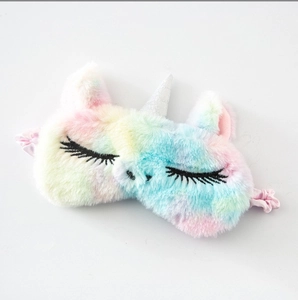 Detailed close-up of the rainbow plush unicorn sleep mask with soft fur and silver horn