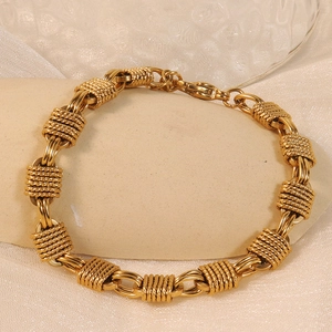 Heavy industrial knot gold titanium steel necklace on beige stone and white silk