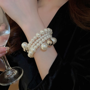 Close-up of elegant multi-layered pearl bracelet with silver beads on a woman wrist