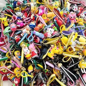 Detailed pile of colorful silicone cartoon character keychains and wrist strap charms