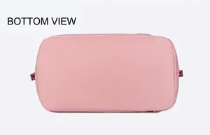 Detail view of pink waterproof travel bag bottom with reinforced stitching and smooth zippers