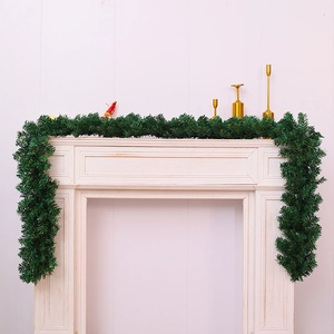 Green 2.7m artificial Christmas garland decorated on a fireplace for festive home decor