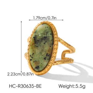 Macro detail of French vintage gold ring with turquoise stone and hammered texture border
