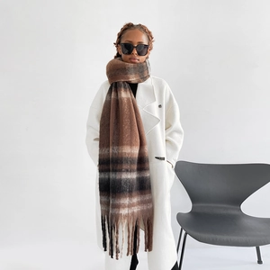 Detail of soft brown plaid mohair scarf featuring long tassels and fluffy texture