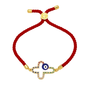 Red cord bracelet with gold cross and blue evil eye charm featuring colorful zircon stones