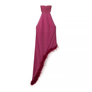 Detail of magenta halter neck dress featuring sequin fabric and feather trim hem