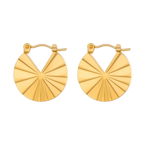 Macro detail of golden pleated fan-shaped hoop earrings in polished titanium steel