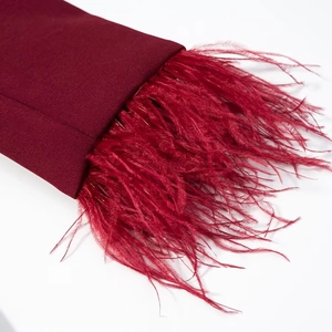 Deep red blazer suit with luxurious feather cuffs and premium woven fabric texture