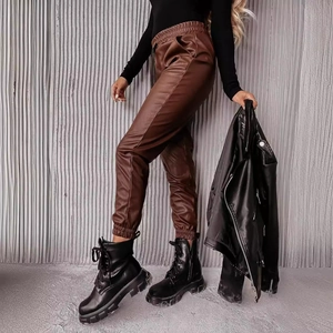 Pantaloni in pelle PU marroni da donna con stivali neri e top attillato a maniche lunghe