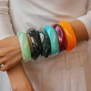 Close-up of colorful resin bracelets with marble texture and high-gloss finish