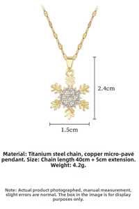 Detail of gold snowflake pendant necklace with dimensions 1.5cm by 2.4cm and titanium chain