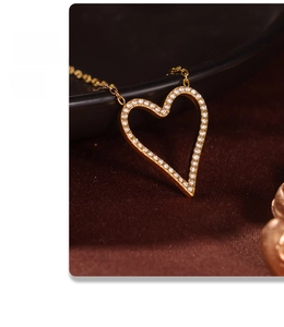 Macro view of gold heart necklace pendant with sparkling white cubic zirconia stones