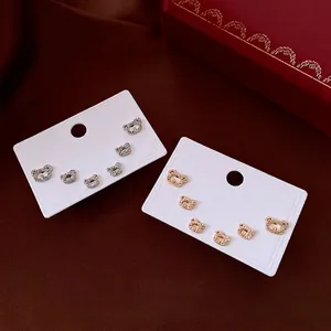 Minimalist silver needle bear stud earrings with white zircons in gold and silver finish