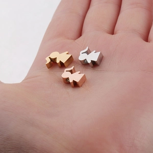 Polished steel family girl charms in gold, silver, and rose gold held in hand