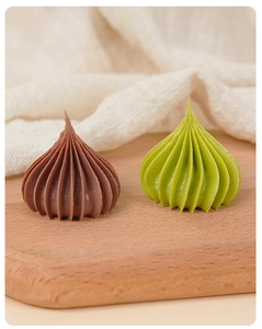 Detailed macro of miniature dollhouse ice cream swirls in chocolate and matcha green