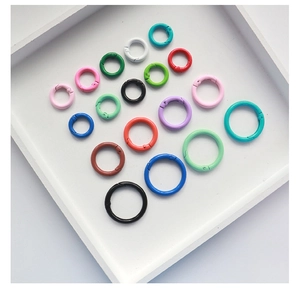 Close-up of 2.5cm colorful lacquered metal spring rings for DIY crafts and keychains