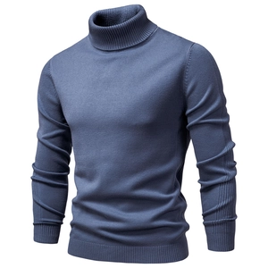 Detailed close-up of light blue knit sweater showing ribbed texture on turtleneck and hem