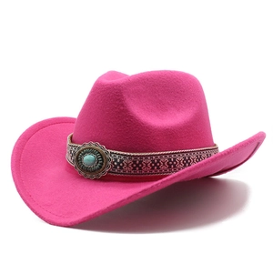 Detail of rose red wool felt cowboy hat with ethnic ribbon and turquoise stone buckle