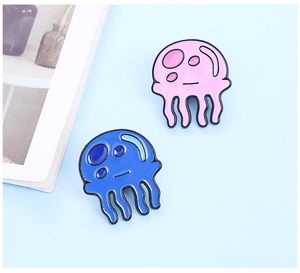 Detail of pink and blue enamel jellyfish brooches with cute cartoon aesthetic