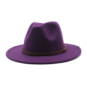 Detail of purple wool fedora hat with a thin brown band on a white background