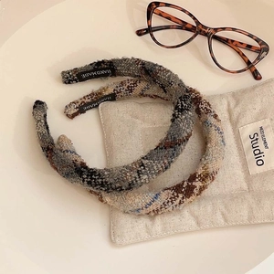 Elegant tweed plaid headbands in grey and beige tones with handmade label detail