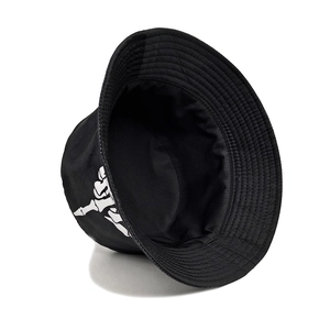 Black reversible bucket hat with white skeleton hand print for outdoor sun protection