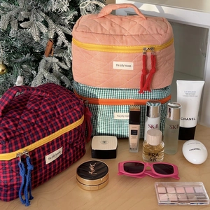 Quilted checkered cosmetic bags in three colors with fabric handles and zippers
