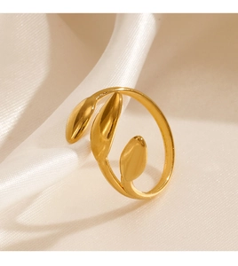 Detailed view of 18K gold plated three-leaf stainless steel ring on silk fabric