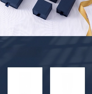 Navy blue drawer style jewelry gift boxes with textured surface and elegant gold ribbons