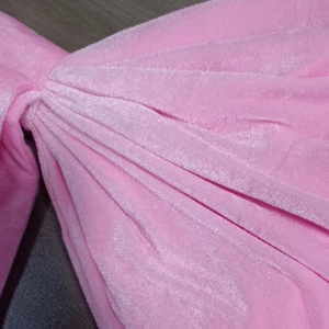Close-up of pink velvet fabric texture with soft folds for decorative butterfly bow decor