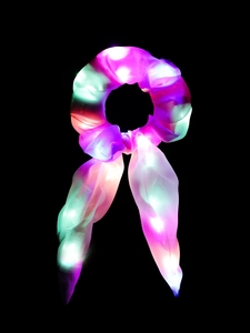Detail of LED glowing hair scrunchie with colorful lights and long flowing ribbons