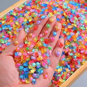Luminous resin mini turtles held in hand, colorful DIY craft charms and tiny ornaments