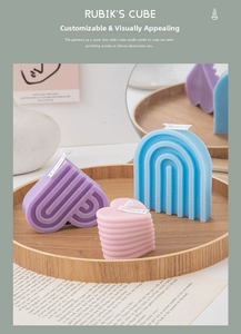 Pastel geometric scented candles in heart and arch shapes on a rustic wooden tray