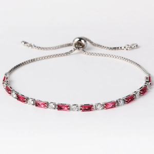 Detail of silver tennis bracelet featuring red rectangular zircons and adjustable slider