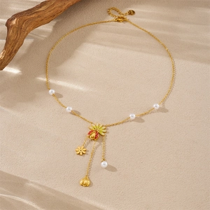 Detail of ladybug and flower charms on a gold-plated pearl necklace with S925 stamp