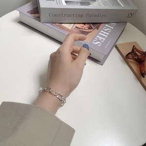 Minimalist S925 sterling silver long link chain bracelet for women on modern book background