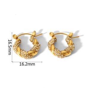 Detailed macro view showing the 16.5mm size of gold twist hoop earrings with crystals